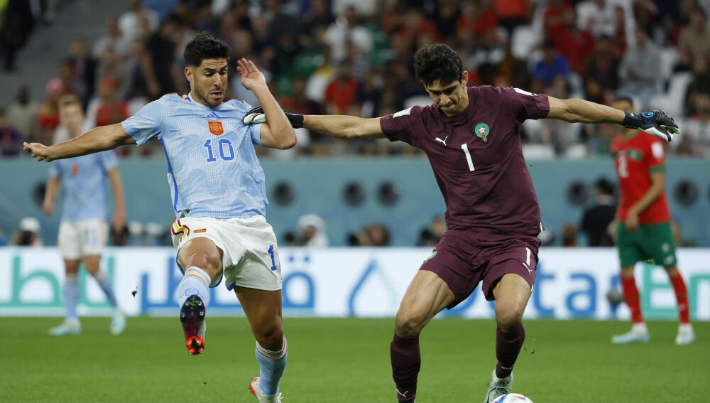 Yassine Bounou (Marruecos) disputa un balón con Marco Asensio (España) en octavos de final del Mundial de Qatar 2022